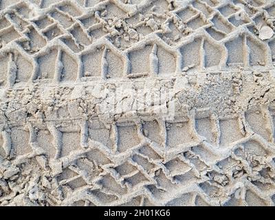 close up of tire track pattern in beach sand Stock Photo