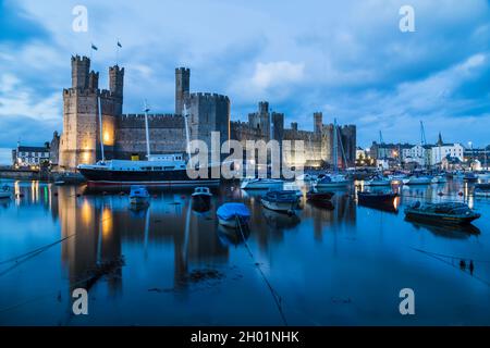 Caernarfon waterfront at twilight on the North Wales coast pictured in October 2021. Stock Photo