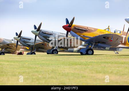 Supermarine spitfires lined up on the flight line of Duxford Stock Photo