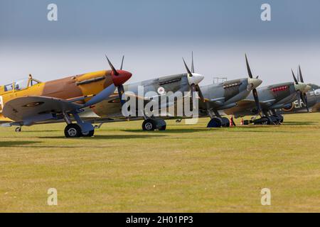 Supermarine spitfires lined up on the flight line of Duxford Stock Photo
