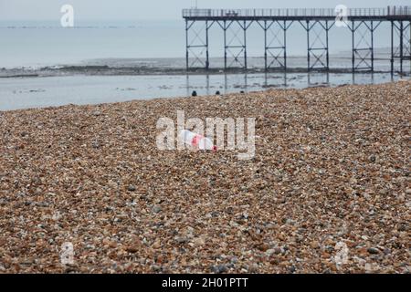 Empty plastic bottle seen on the beach of Bognor Regis. Stock Photo