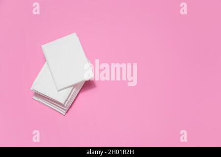 White paper tissues on dark pink background. Stock Photo