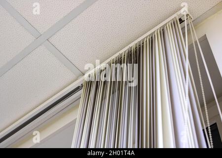 White blinds on the window on ceiling close up Stock Photo