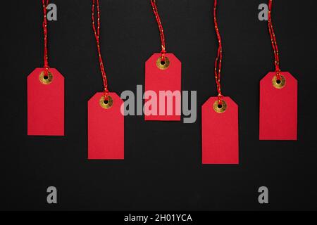 Red sale tags on a black background. Discounts and Black Friday concept. Top view, copy space for text Stock Photo