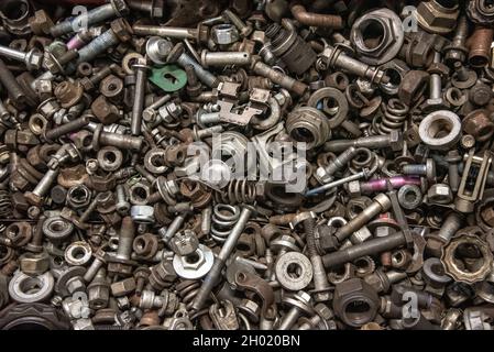Box of random nuts and bolt, parts, washers, screws in workshop garage. Stock Photo
