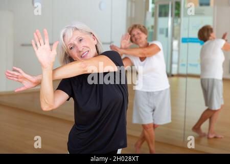 Portrait of an elderly dancing woman practicing vigorous swing Stock Photo