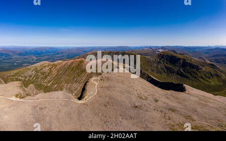Panoramic aerial view of the summit of Ben Nevis - the tallest mountain in Scotland and the UK on a clear, sunny day Stock Photo