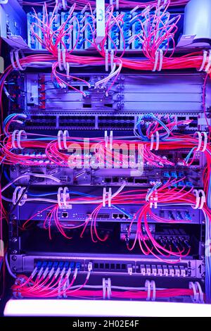 Arrangement of red fiber optic cables in server hardware Stock Photo