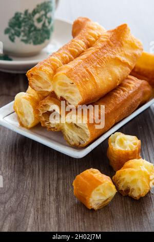 Youtiao (Chinese fried breadstick). Long golden brown deep fried dough strip. Stock Photo