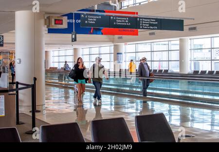 Midway airport Chicago IL USA; June 3, 2021; travelers in masks walk through a somewhat empty airport during the covid pandemic Stock Photo