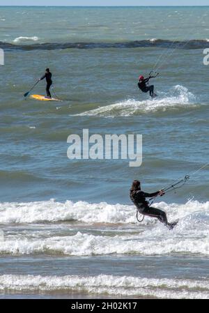 St Joseph MI USA, Sept 26, 2021; e kite surfers and a person on a surf board, enjoy a windy day on Lake Michigan Stock Photo