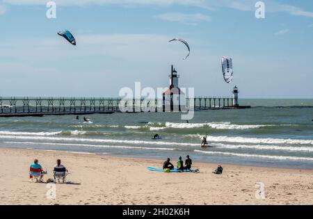St Joseph MI USA, Sept 26, 2021; kite boarders and surfers play on the lake by the St Joseph light house Stock Photo