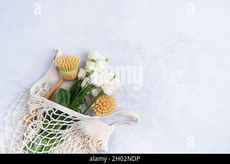 Plastic free set with cotton bag, glass jar, green leaves and recycled tableware. Zero waste, eco friendly concept. Flat lay, top view, copy space Stock Photo