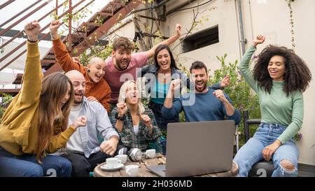 Creative business people hand raise up partnership teamwork concept in front of a laptop monitor screen in the rooftop. Stock Photo