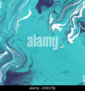 Acrylic texture made in fluid pour technique. Background in blue, turquoise and white colors. Stock Photo