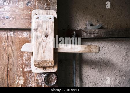 Ancient or antique wooden lock on a wooden door. Ionian Greek architecture. Stock Photo