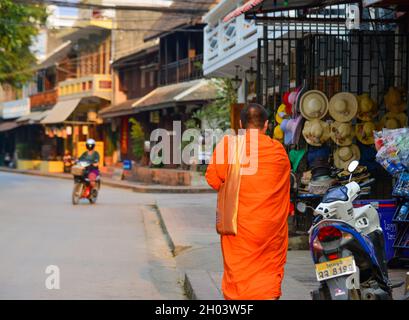 Luang Phrabang, Laos - Feb 4, 2020. Buddhist monk walking on street in Luang Phrabang, Laos. The city was the capital of the kingdom of Laos until 197 Stock Photo