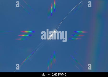 Abstract rainbow lens flare effect on a crack in the window, cross refraction effect Stock Photo