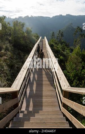 Two young women walking side by side on the Passadiços das Fragas de São Simão wooden walkway in central Portugal, Europe Stock Photo