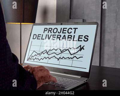 Project deliverables with charts on the laptop screen. Stock Photo