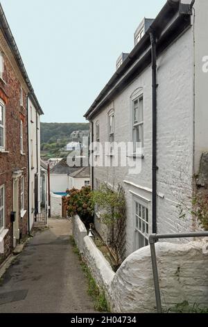 The South West Coast Path travels through a narrow lane in the twin villages of Kingsand and Cawsand in the south east corner of Cornwall. Stock Photo