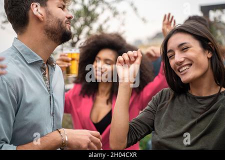 Group of friends having fun dancing together on the rooftop Stock Photo