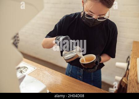 Female person working in cafeteria in covid-19 Stock Photo