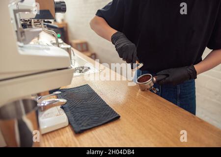 Barista working in cafeteria in covid-19 pandemic Stock Photo