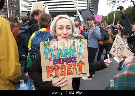 The Hague, Netherlands. 11th Oct, 2021. Extinction Rebellion environment activists block the street during protest near Dutch Parliament on October 11, 2021 in The Hague, Netherlands. Environmental protestors of Extinction Rebellion make a demonstration drawing attention, all over the world people are being killed by famine and natural disasters caused by the climate and ecological emergency ahead of the upcoming COP26 summit in Glasgow in November. (Photo by Paulo Amorim/Sipa USA) Credit: Sipa USA/Alamy Live News Stock Photo