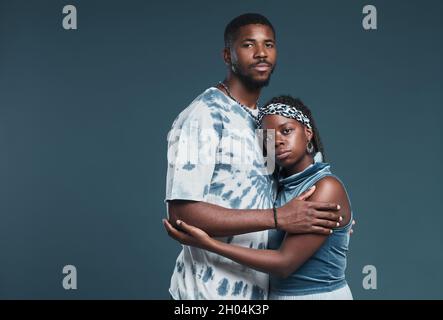 Waist up portrait of young African-American couple wearing casual street style clothes while posing against blue and looking at camera, copy space Stock Photo