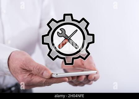 Settings concept above a smartphone held by hands Stock Photo