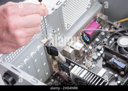 Installing graphics card in a computer Stock Photo