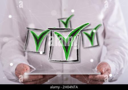 Validation concept above a tablet held by a man in background Stock Photo