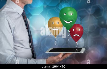 Customer satisfaction concept above a tablet held by a man Stock Photo
