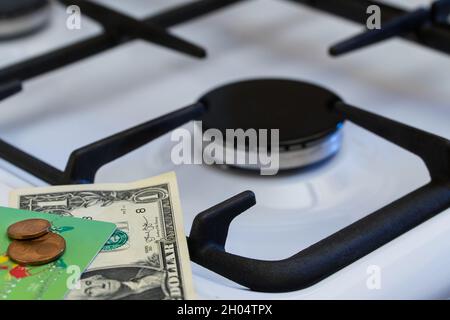 Shortage and gas crisis. Money on the background of a switched off gas stove Stock Photo