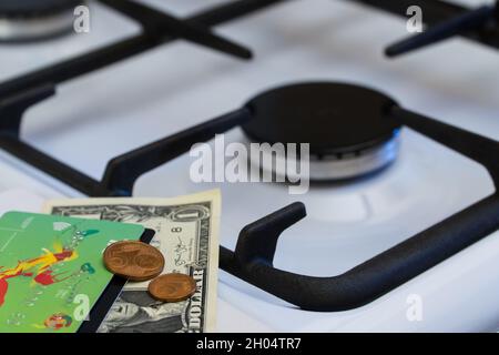 Shortage and gas crisis. Money on the background of a switched off gas stove Stock Photo