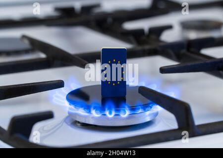 Shortage and gas crisis. Flag of the European Union on a burning gas stove Stock Photo