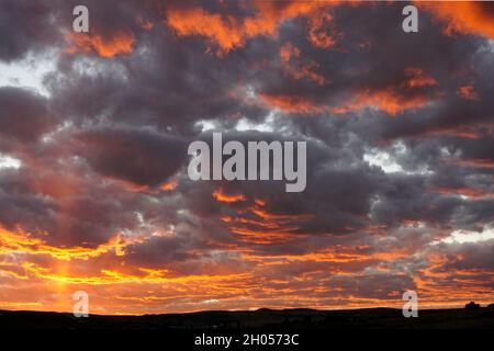 Dramatic sky with orange and purple clouds just after sunset Stock Photo