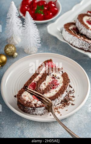 Black forest cake roll with whipped cream and cherries, dessert for Christmas Stock Photo