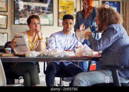 Group of coworkers having competition together at the office; Casual workplace concept Stock Photo