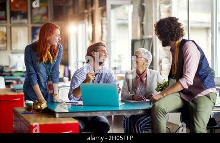 Group of young employees working together with their mentor Stock Photo