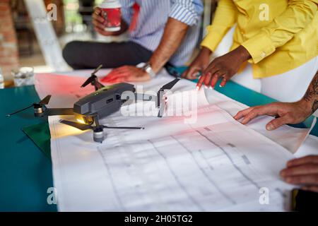 Group of colleagues collaborating on a projecting the drone together Stock Photo