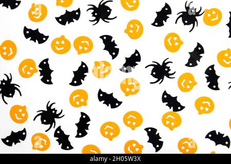 Halloween decorations with spiders and bats on a white background. Top view, copy space, flat lay. Stock Photo