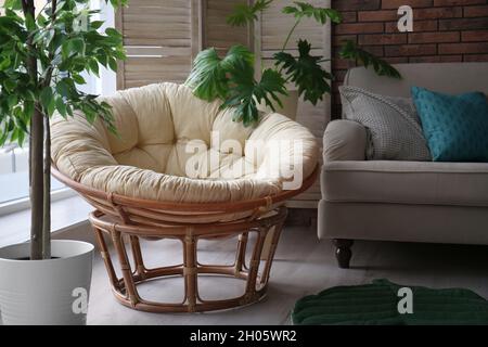 Cozy apartment with lounge round chair near window. Type of