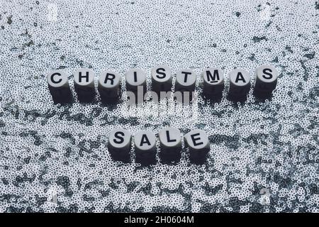 Christmas sale, black Friday silver metallic background. Text Christmas sale on festive glitter shiny luxury background with sequins Stock Photo
