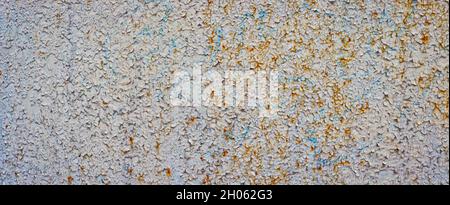 Old rusty metal surface with peeling paint. Stock Photo