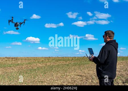 The pilot controls a professional drone Stock Photo