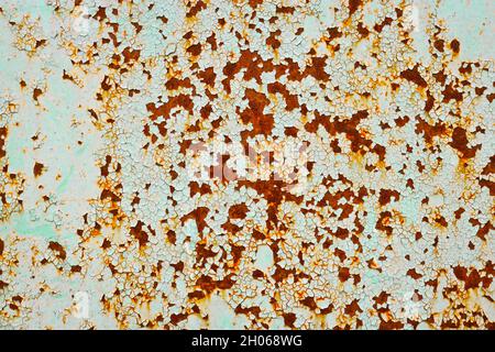 Old rusty metal surface with peeling paint. Stock Photo