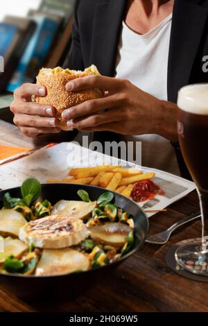A young bearded man having lunch in an urban pub Stock Photo