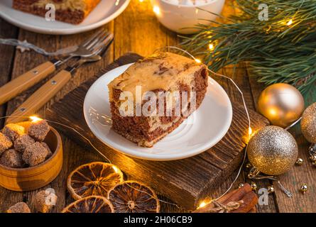 Zebra cake with cocoa on a festive Christmas background. Side view, close-up Stock Photo